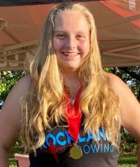 Photo of teen athlete Leila wearing a gold medal